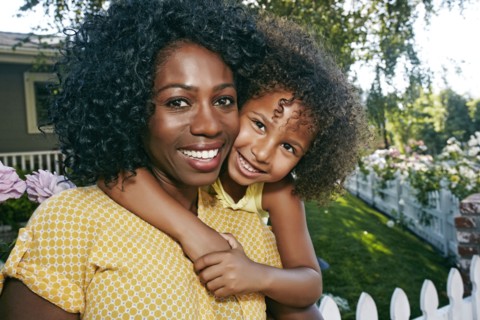 Daughter hugging mother outdoors