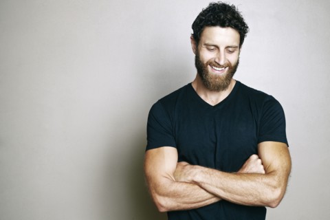 Smiling Caucasian man with beard looking down