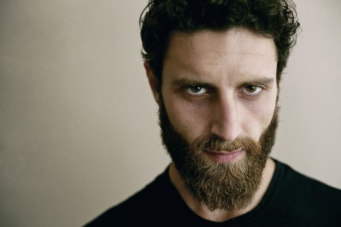 Serious Caucasian man with beard looking at camera