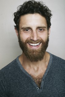 Smiling Caucasian man with beard looking at camera