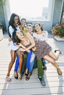 Friends laughing at rooftop party