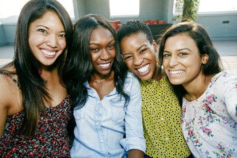 Smiling women posing on rooftop