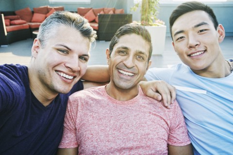 Smiling men posing on rooftop
