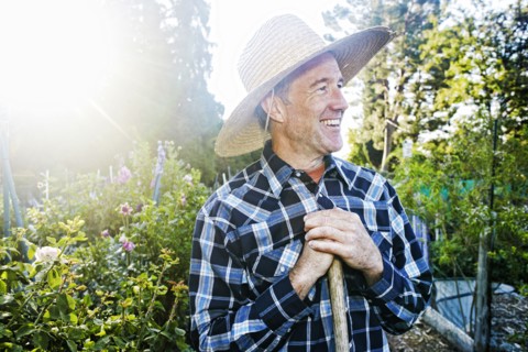 Smiling Caucasian man standing in garden