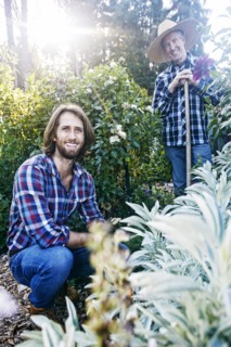 Smiling Caucasian men posing in garden
