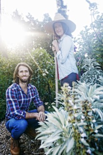 Smiling Caucasian couple posing in garden