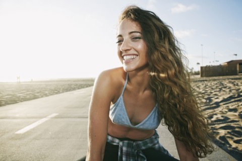 Portrait of Caucasian woman smiling on path at beach