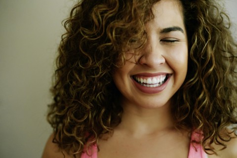 Portrait of laughing Mixed Race woman