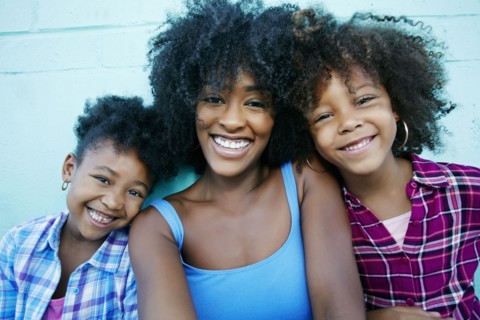 Portrait of smiling mother and daughters