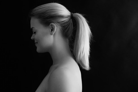 Profile of smiling Caucasian woman with ponytail