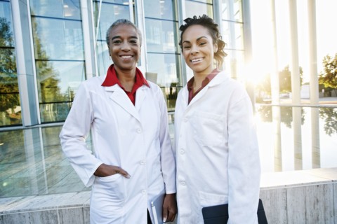 Portrait of smiling doctors outdoors at hospital