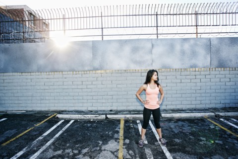 Mixed race woman standing in parking lot