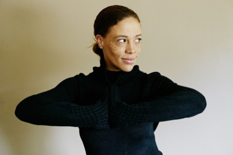 Mixed race woman wearing sweater looking away