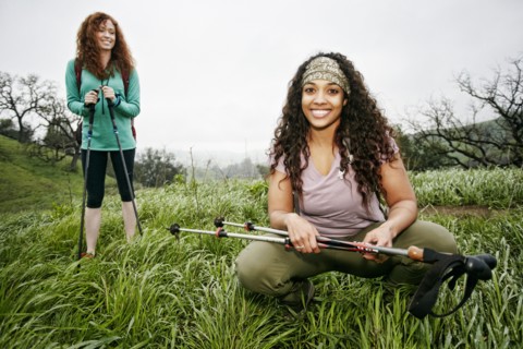 Portrait of smiling women hiking with walking sticks