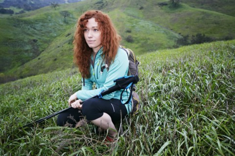 Portrait of Caucasian woman crouching holding walking sticks