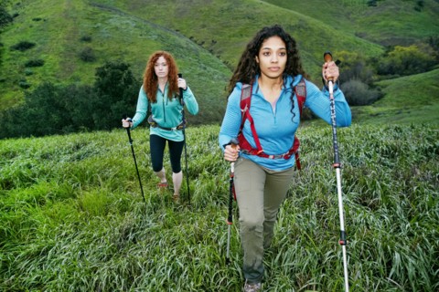 Serious women hiking with walking sticks