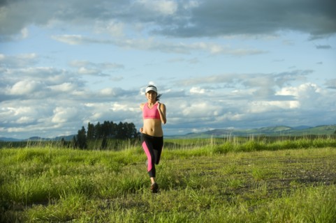 Japanese woman running in field