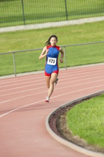 Japanese runner running on racetrack