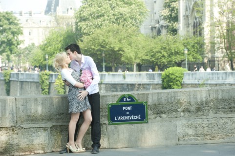 Caucasian couple kissing on Pont de L'Archeveche