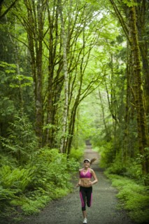 Caucasian woman running on remote path