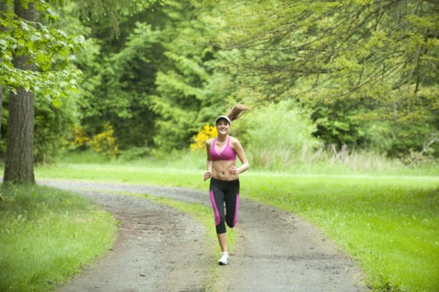 Caucasian woman running on remote path