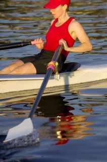 Person rowing sculling boat on river