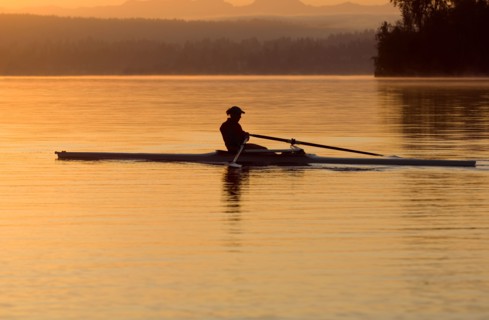 Person rowing sculling boat on river