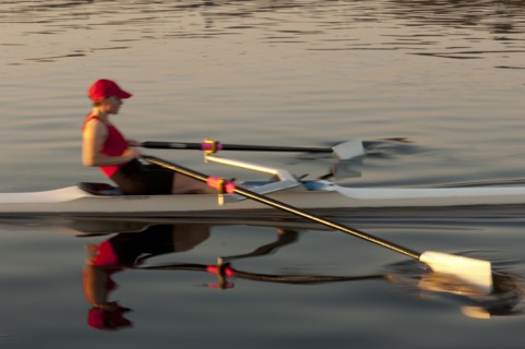 Person rowing sculling boat on river