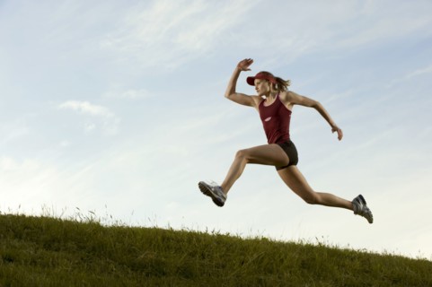 Caucasian runner running in field