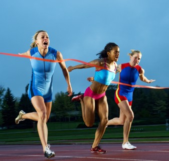 Runners crossing finish line in race