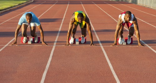 Black runners at starting block in race