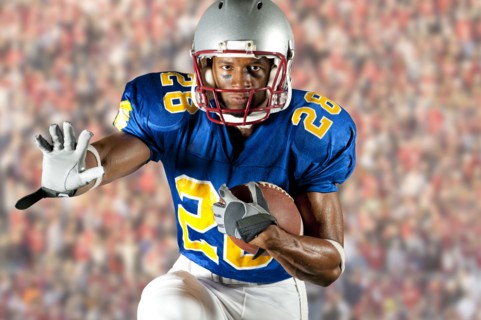 Black football player running with football