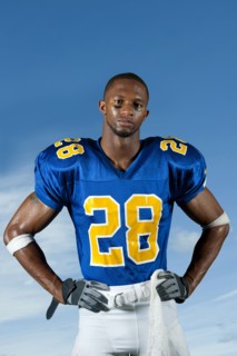 Black football player standing with hands on hips