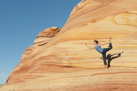 Caucasian woman practicing yoga outdoors