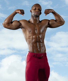Black football player flexing muscles