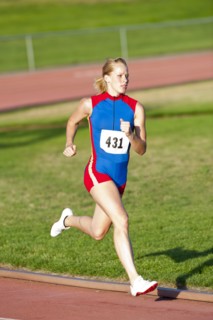 Caucasian runner running on track