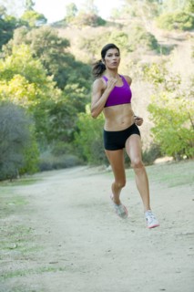 Hispanic woman running on remote path