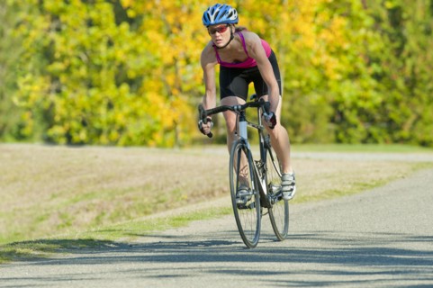 Caucasian woman riding bicycle in park