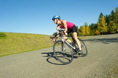 Caucasian woman riding bicycle in park