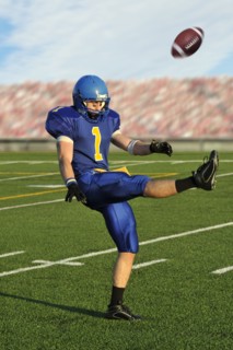 Caucasian football player kicking football