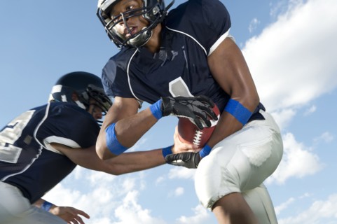 Football players passing ball