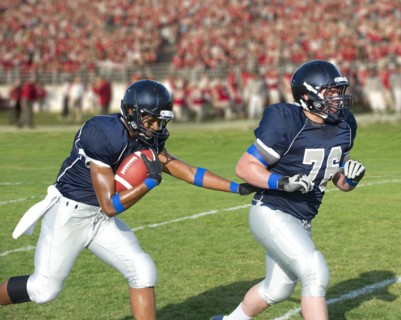 Football players passing ball
