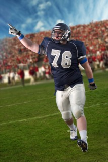 Caucasian football player cheering in game