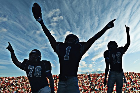Football players cheering in game