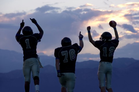 Football players cheering in game