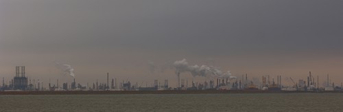 Smoke billowing from distant factory