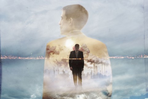 Double exposure of businessman and urban coastline