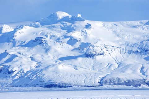 Iceberg looming over arctic landscape