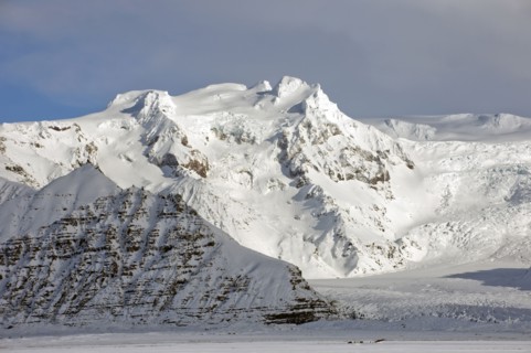 Iceberg looming over arctic landscape