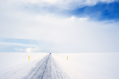 Tire tracks on rural road in snowy landscape